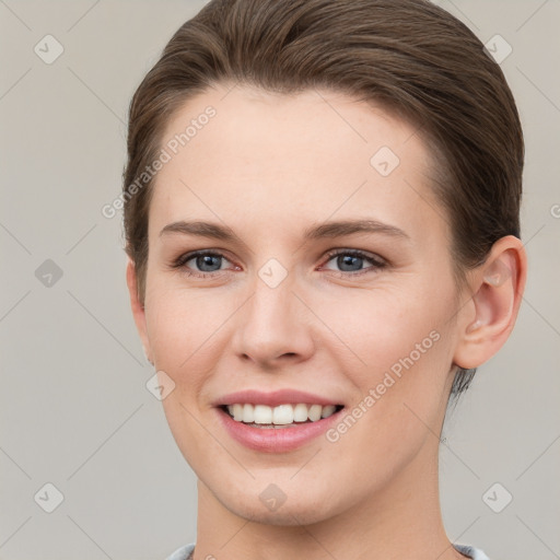 Joyful white young-adult female with short  brown hair and grey eyes