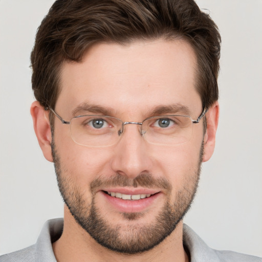 Joyful white young-adult male with short  brown hair and grey eyes