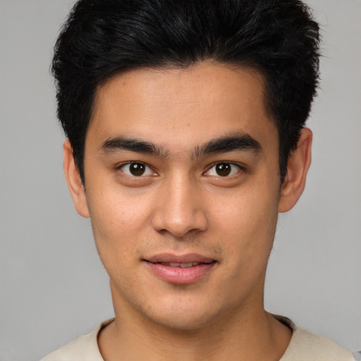 Joyful asian young-adult male with short  black hair and brown eyes