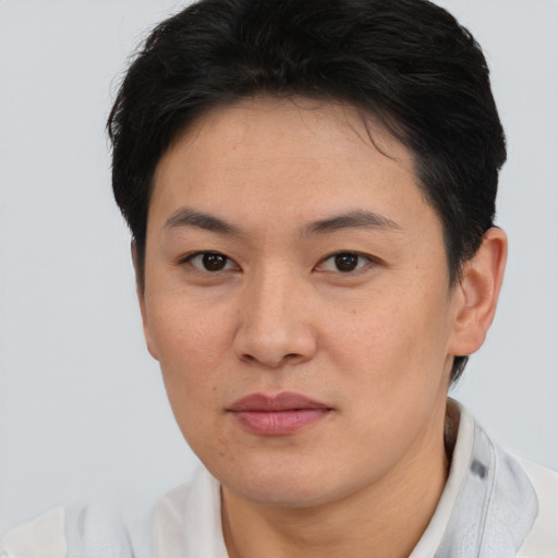 Joyful asian young-adult female with short  brown hair and brown eyes