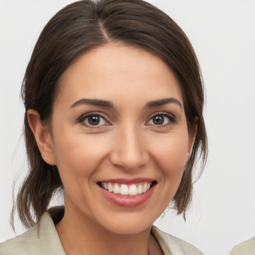 Joyful white young-adult female with medium  brown hair and brown eyes