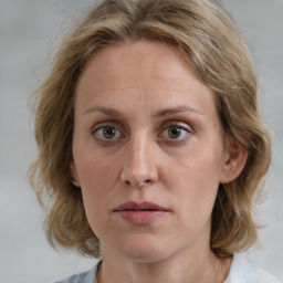 Joyful white adult female with medium  brown hair and blue eyes