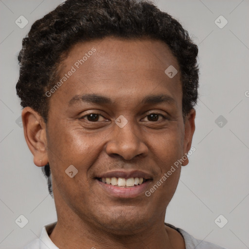 Joyful latino adult male with short  brown hair and brown eyes