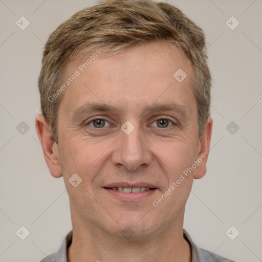 Joyful white adult male with short  brown hair and grey eyes