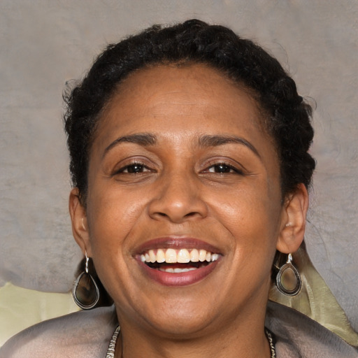 Joyful black adult female with short  brown hair and brown eyes