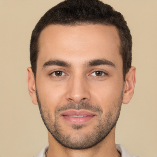 Joyful white young-adult male with short  black hair and brown eyes