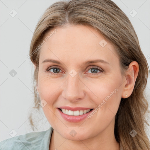 Joyful white young-adult female with long  brown hair and blue eyes