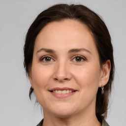 Joyful white adult female with medium  brown hair and brown eyes