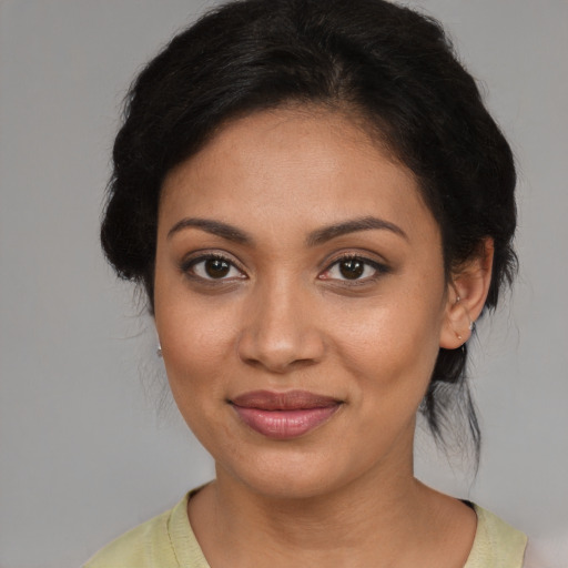 Joyful latino young-adult female with medium  brown hair and brown eyes