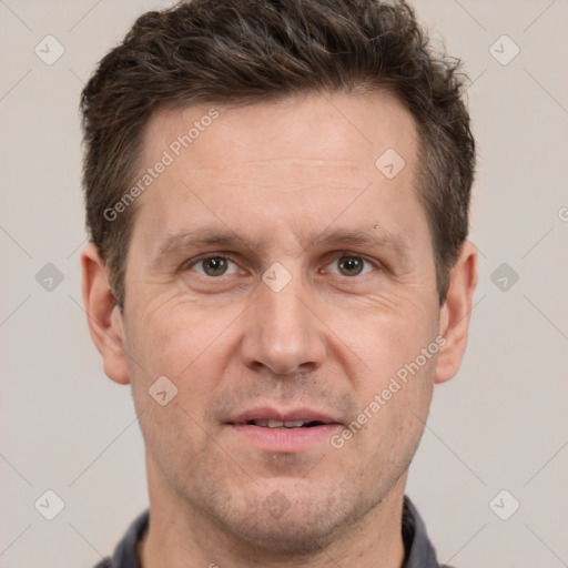 Joyful white adult male with short  brown hair and grey eyes