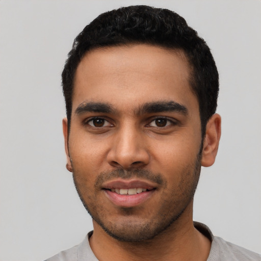 Joyful latino young-adult male with short  black hair and brown eyes