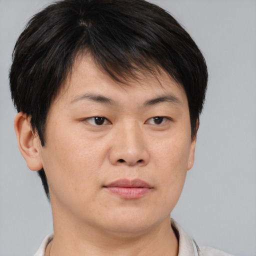 Joyful asian young-adult male with short  brown hair and brown eyes