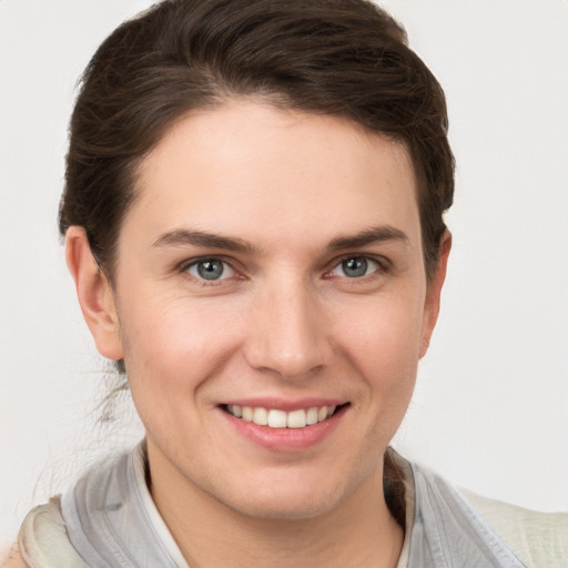 Joyful white young-adult female with short  brown hair and grey eyes