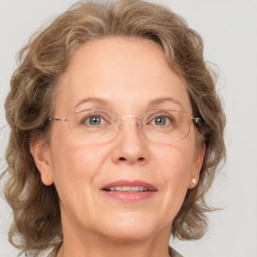 Joyful white middle-aged female with medium  brown hair and blue eyes