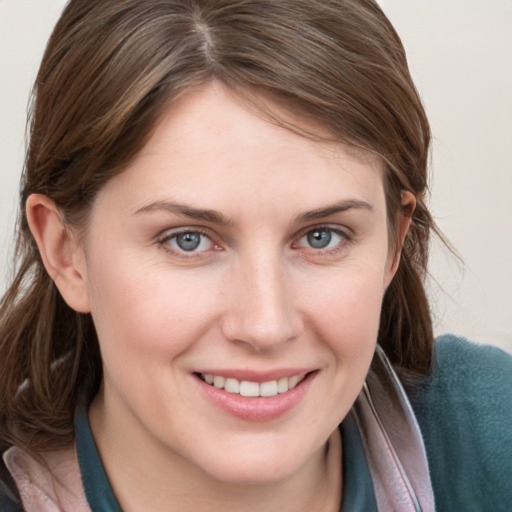 Joyful white young-adult female with medium  brown hair and grey eyes