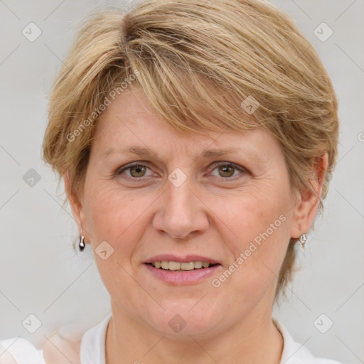 Joyful white adult female with medium  brown hair and blue eyes