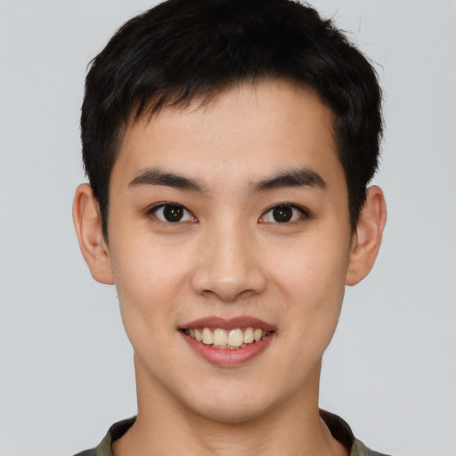 Joyful asian young-adult male with short  black hair and brown eyes