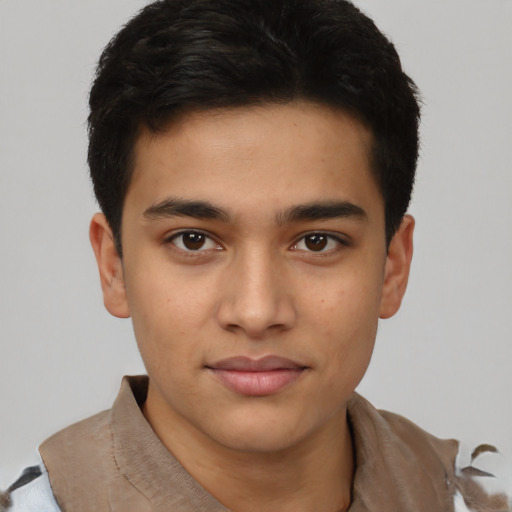 Joyful latino young-adult male with short  brown hair and brown eyes