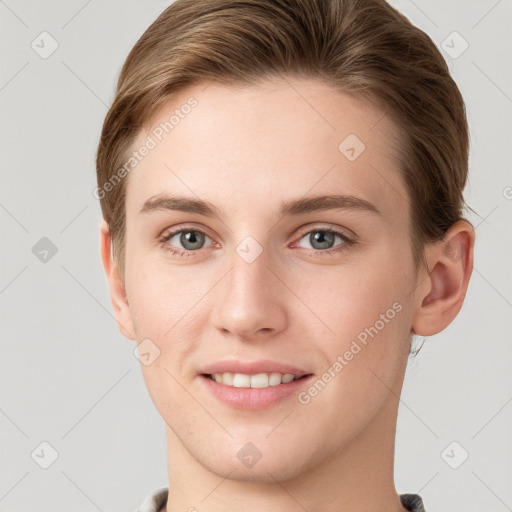 Joyful white young-adult female with short  brown hair and grey eyes