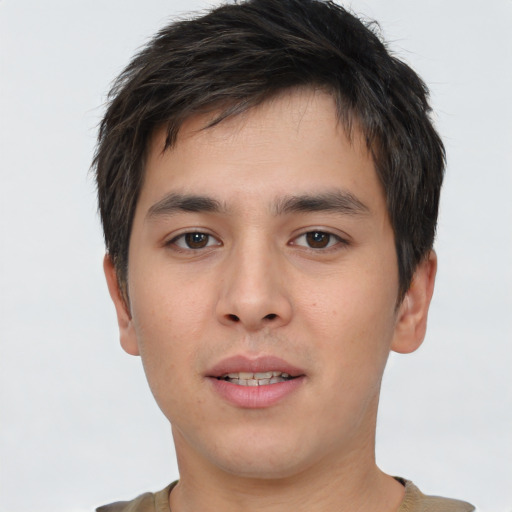 Joyful asian young-adult male with short  brown hair and brown eyes