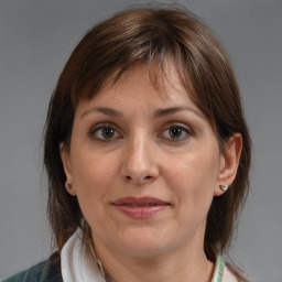 Joyful white adult female with medium  brown hair and brown eyes