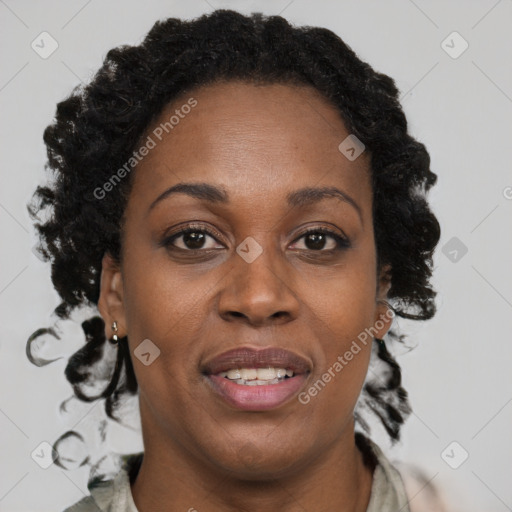 Joyful black adult female with long  brown hair and brown eyes