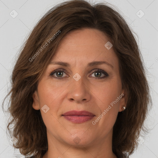 Joyful white adult female with long  brown hair and brown eyes