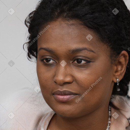 Joyful black young-adult female with long  brown hair and brown eyes