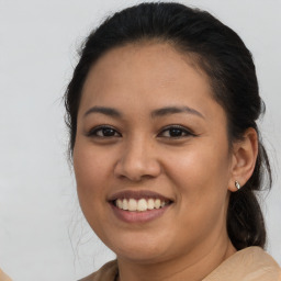 Joyful latino young-adult female with medium  brown hair and brown eyes