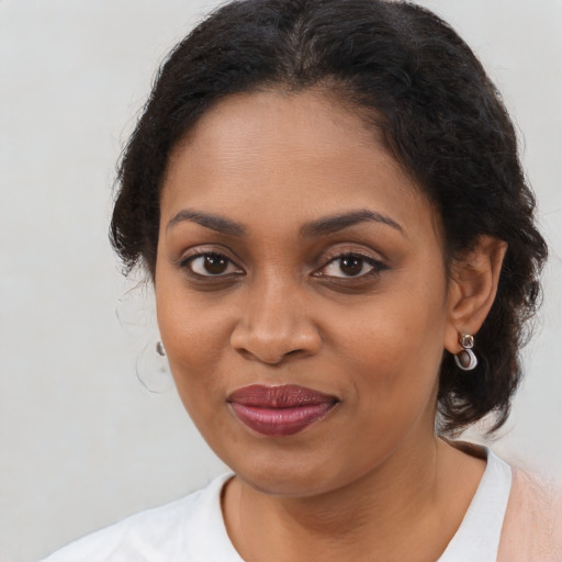 Joyful black young-adult female with medium  brown hair and brown eyes