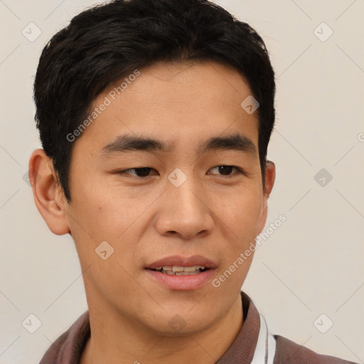 Joyful asian young-adult male with short  brown hair and brown eyes