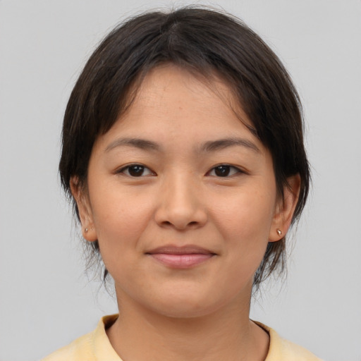 Joyful asian young-adult female with medium  brown hair and brown eyes