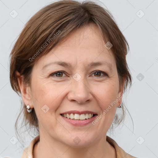 Joyful white adult female with medium  brown hair and grey eyes