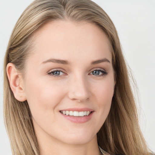 Joyful white young-adult female with long  brown hair and blue eyes