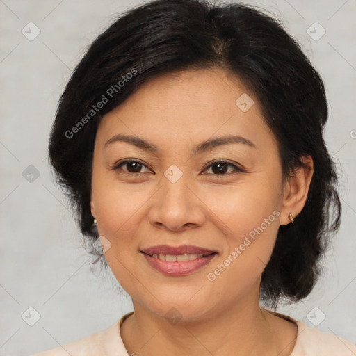 Joyful latino adult female with medium  brown hair and brown eyes