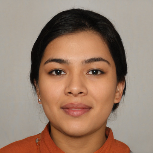 Joyful latino young-adult female with medium  black hair and brown eyes