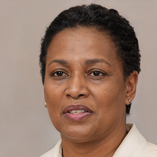 Joyful black adult female with short  brown hair and brown eyes