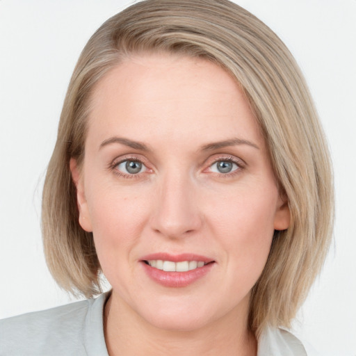 Joyful white young-adult female with medium  brown hair and blue eyes