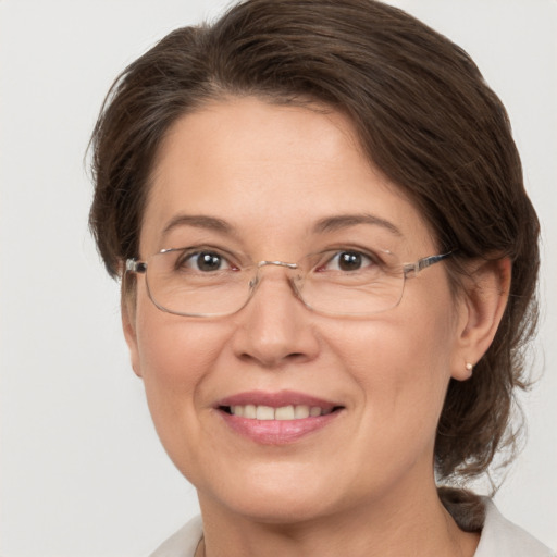 Joyful white adult female with medium  brown hair and grey eyes