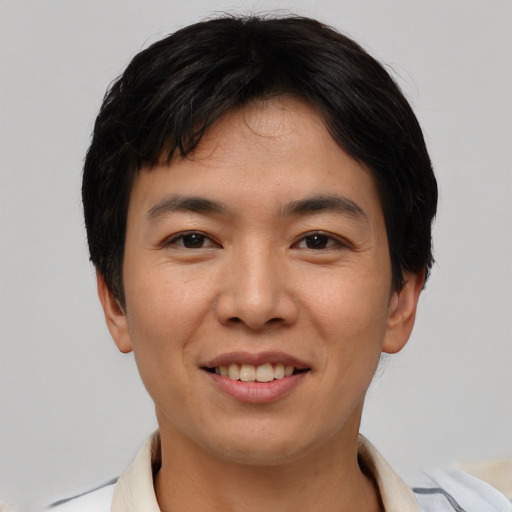 Joyful asian young-adult male with short  black hair and brown eyes