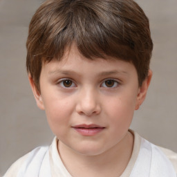 Joyful white child male with short  brown hair and brown eyes