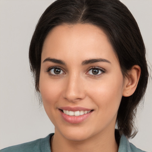 Joyful white young-adult female with medium  brown hair and brown eyes