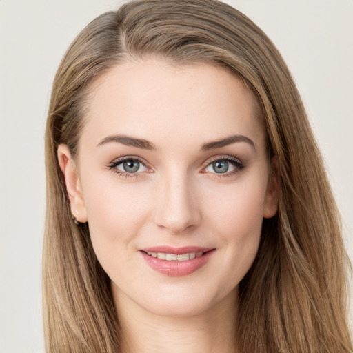 Joyful white young-adult female with long  brown hair and green eyes