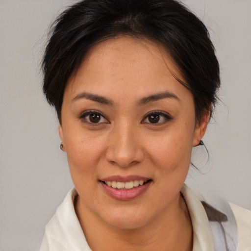 Joyful latino young-adult female with medium  brown hair and brown eyes