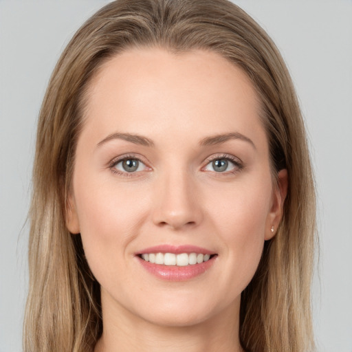 Joyful white young-adult female with long  brown hair and blue eyes