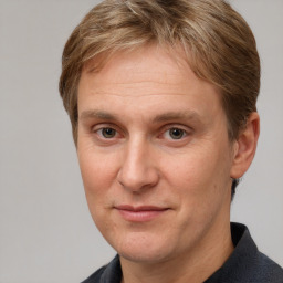 Joyful white adult male with short  brown hair and grey eyes