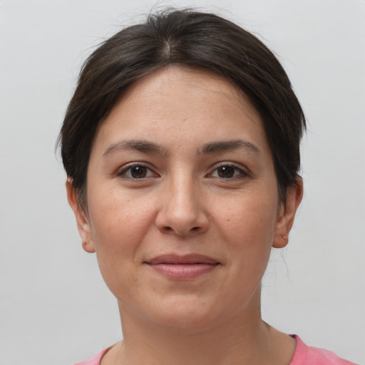 Joyful white young-adult female with short  brown hair and brown eyes