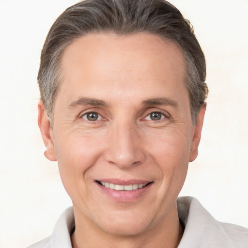 Joyful white adult male with short  brown hair and brown eyes