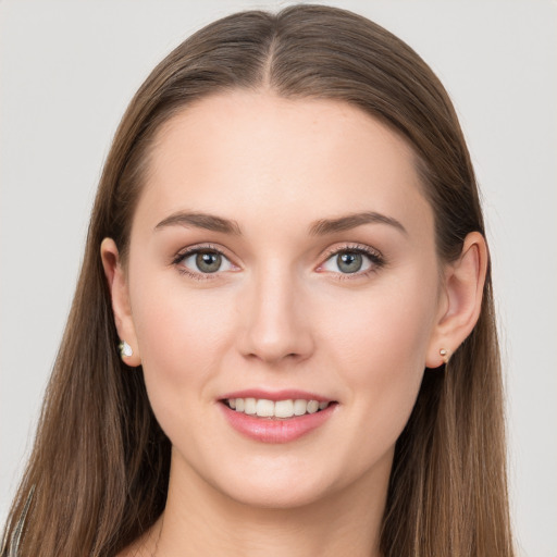 Joyful white young-adult female with long  brown hair and grey eyes