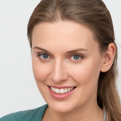 Joyful white young-adult female with long  brown hair and grey eyes